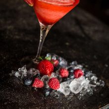 Strawberry cocktail with berries and ice cubes