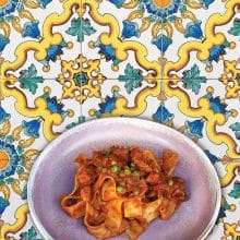 Pasta ragu dish with colourful background