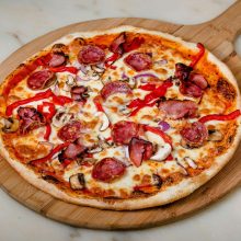 Pizza with salami and capsicum
