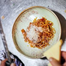pasta bolognese dish topped with parmesan cheese